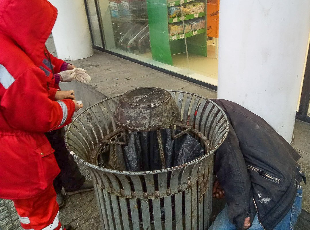 Мужчина лежал возле мусорного контейнера