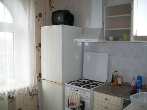 Светлая кухня оснащена всей необходимой техникой