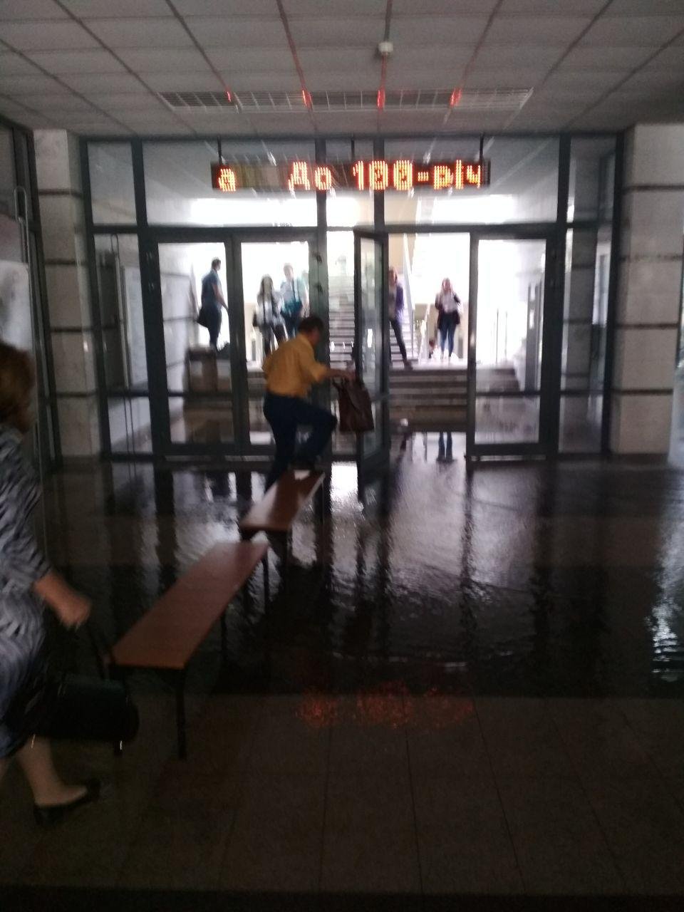 Воды на полу настолько много, что сотрудники вуза соорудили мост из лавочек