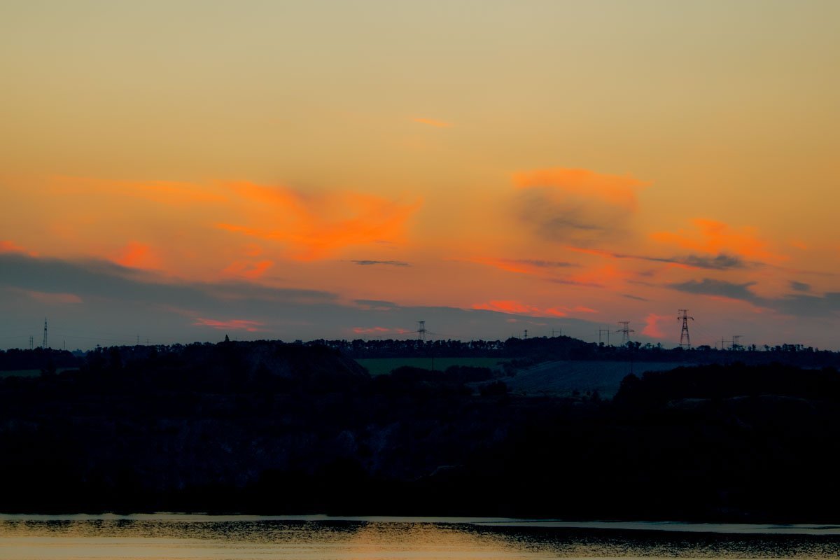 В зеркальных водах реки отражается солнце, восходящее над Днепром