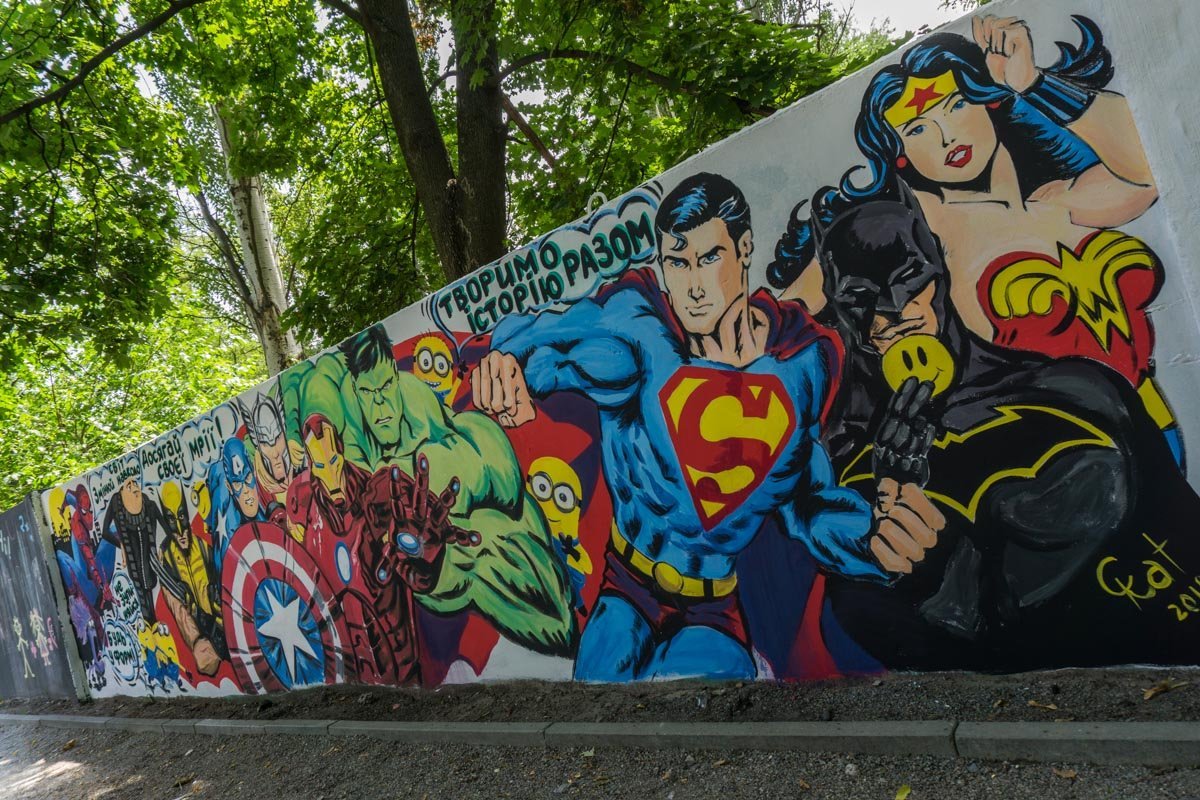 Местным жителям настолько надоел «скучный» бетонный забор возле детской площадки, что они решили добавить в детство малышей немного ярких красок