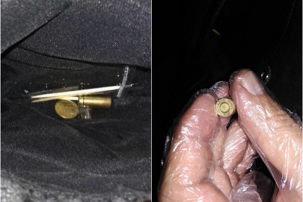 В кармане сумки другого - несколько патронов