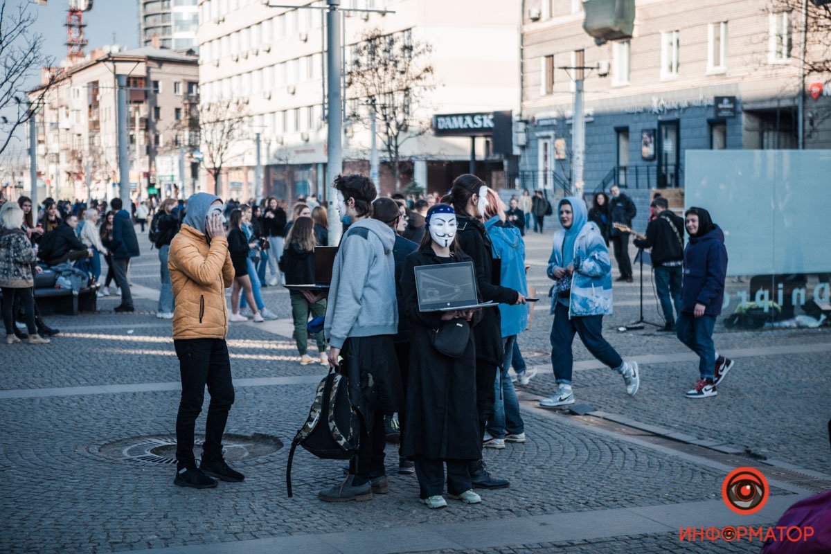 Молодые люди стояли спиной друг к другу, а в руках у них были ноутбуки Молодые люди стояли спиной друг к другу, а в руках у них были ноутбуки