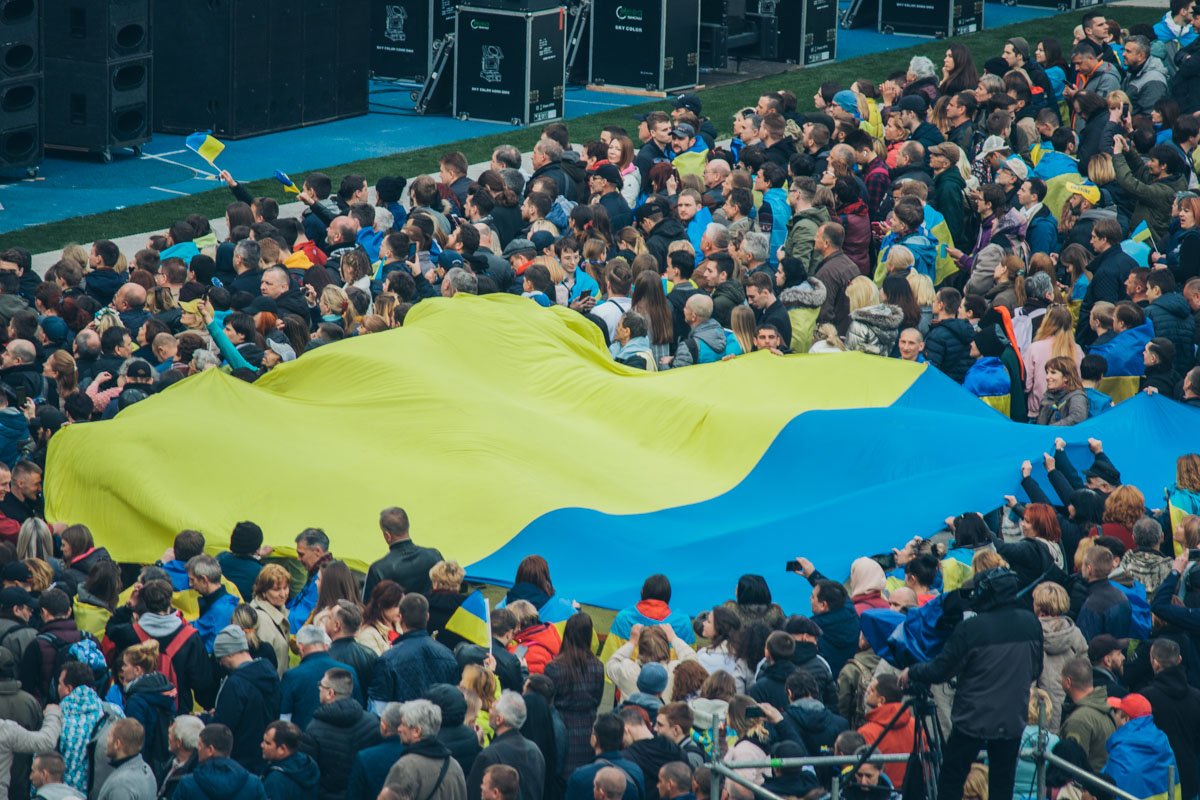 На стадионе собралась многотысячная толпа, растянув флаг Украины