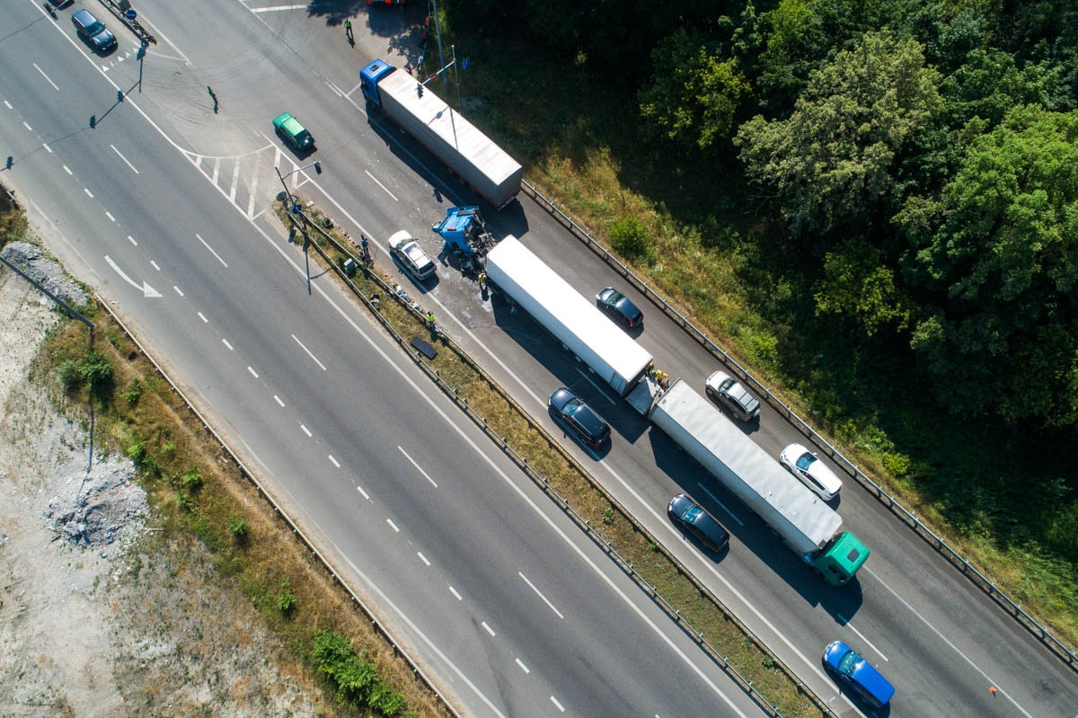 Возле него остановился еще один грузовик, который разгружал фуру Возле него остановился еще один грузовик, который разгружал фуру