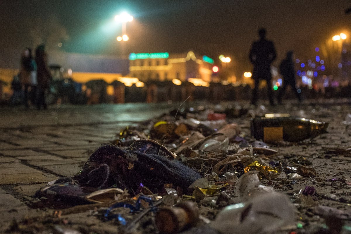 Вдоль тротуара лежит куча мусора 