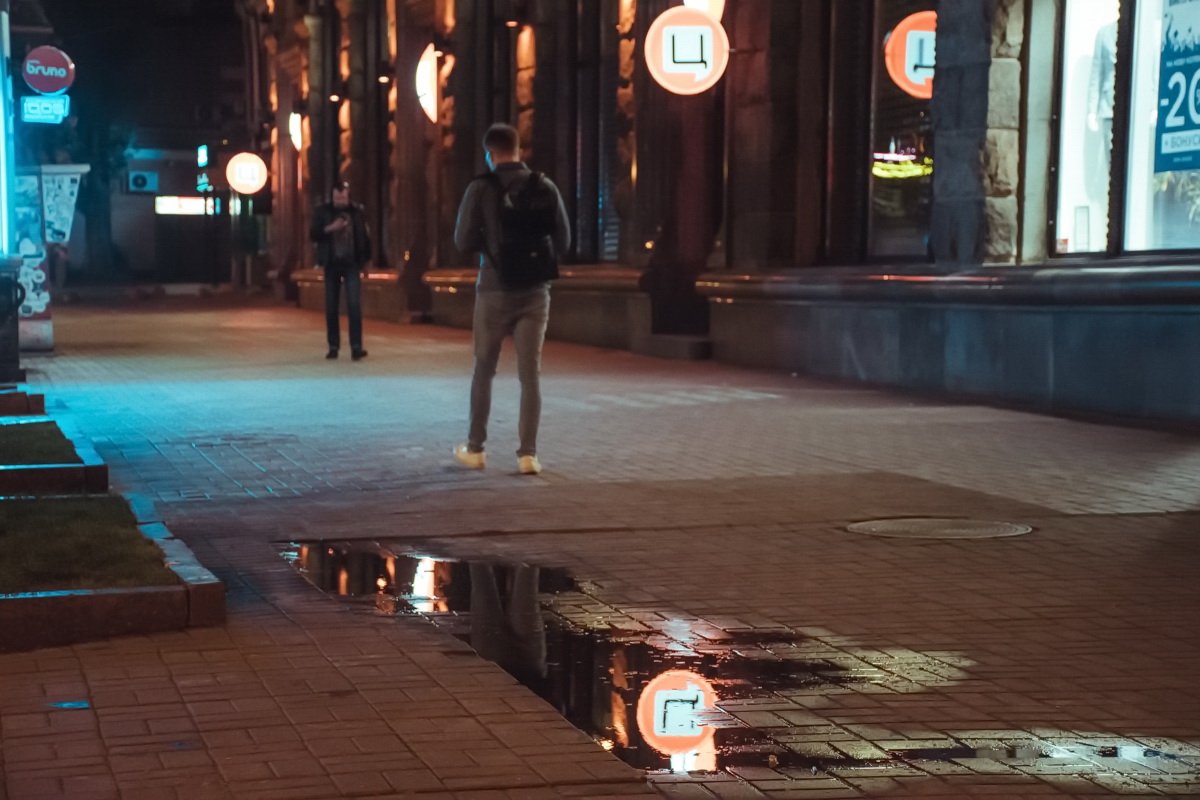 На центральной улице города так поздно еще ходят люди На центральной улице города так поздно еще ходят люди