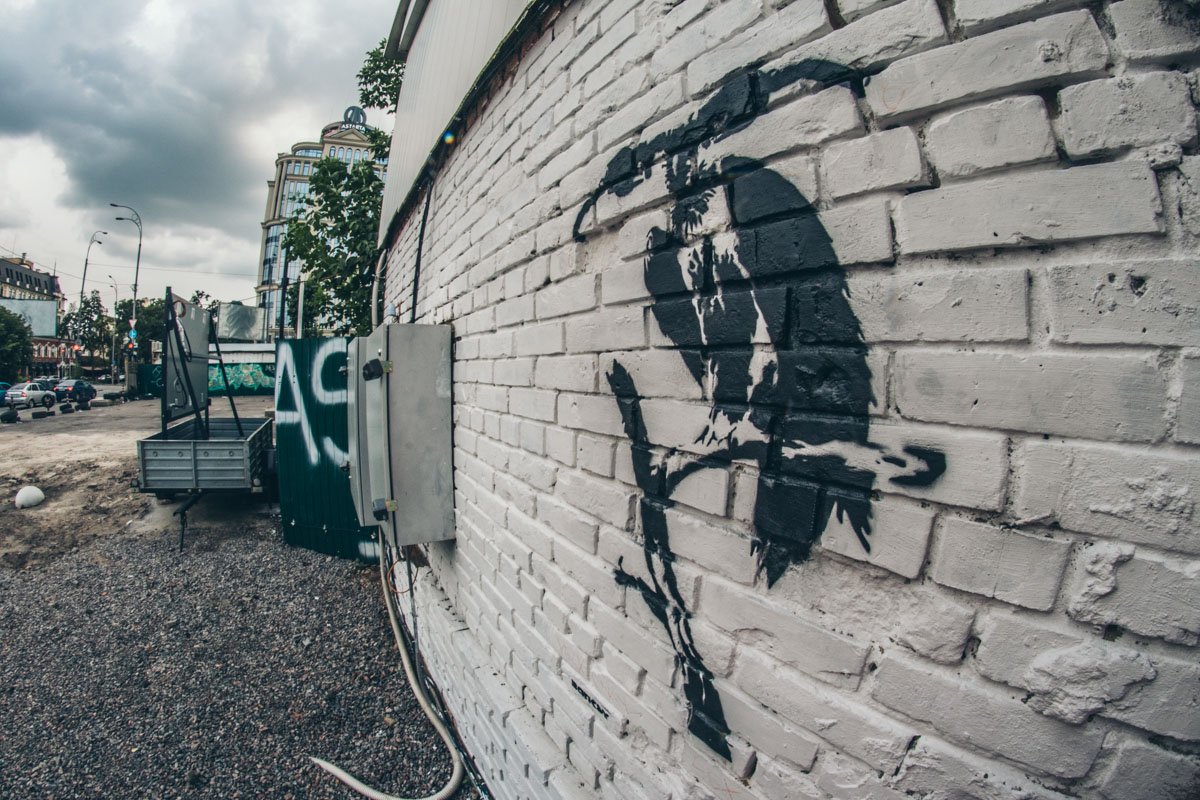 На стене около заправки Тoka в Киеве появился двуглавый стервятник с заправочными пистолетами вместо головы