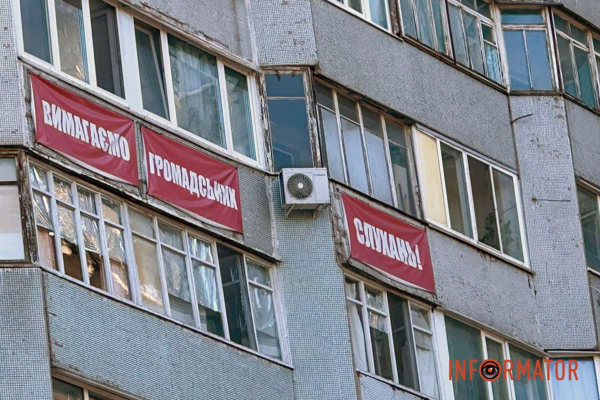 На фасаде соседней 16-этажки с муралом кита до сих пор висят плакаты выступающих против застройки жителей. Несмотря на недовольство общины: в Днепре на Солнечной Набережной активно возводят новый небо