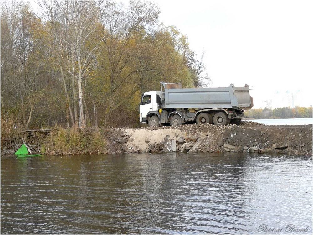 Канал засыпают строительным мусором.