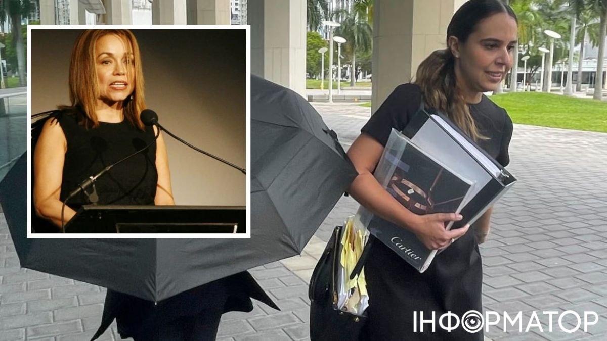 Нэнси Гонсалес прячется под зонтиком возле суда, рядом с ней ее адвокат. Нэнси Гонсалес прячется под зонтиком возле суда, рядом с ней ее адвокат.