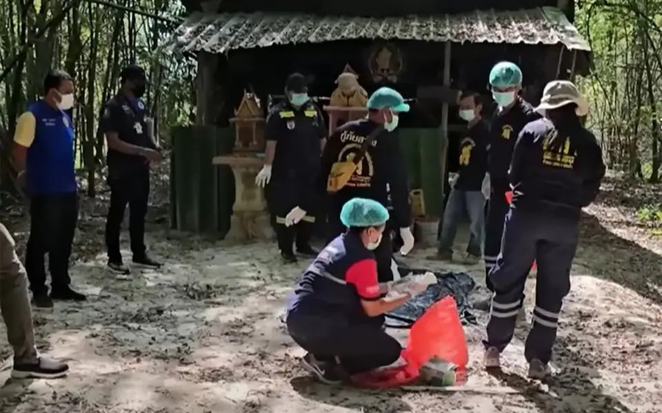 Police and rescue workers examine evidence at Pa Nakhon Chaiboworn Monastery on Saturday