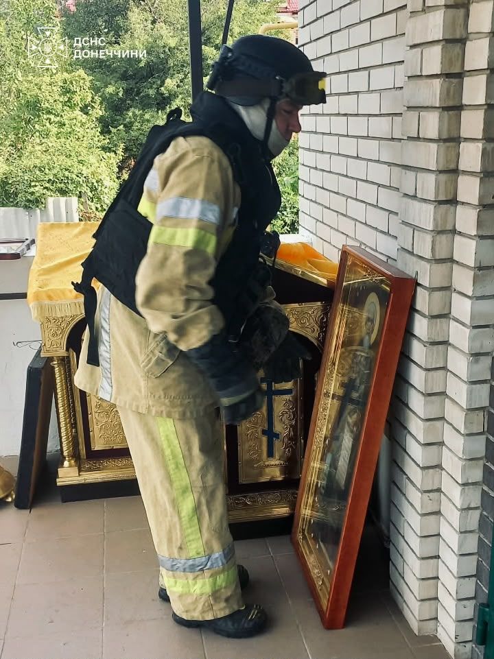 Рятувальники виносять ікони з вогню Рятувальники виносять ікони з вогню